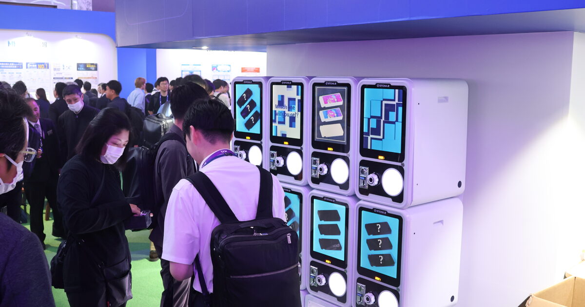 展示会イベントでガチャマシンに集まる大勢の来場者